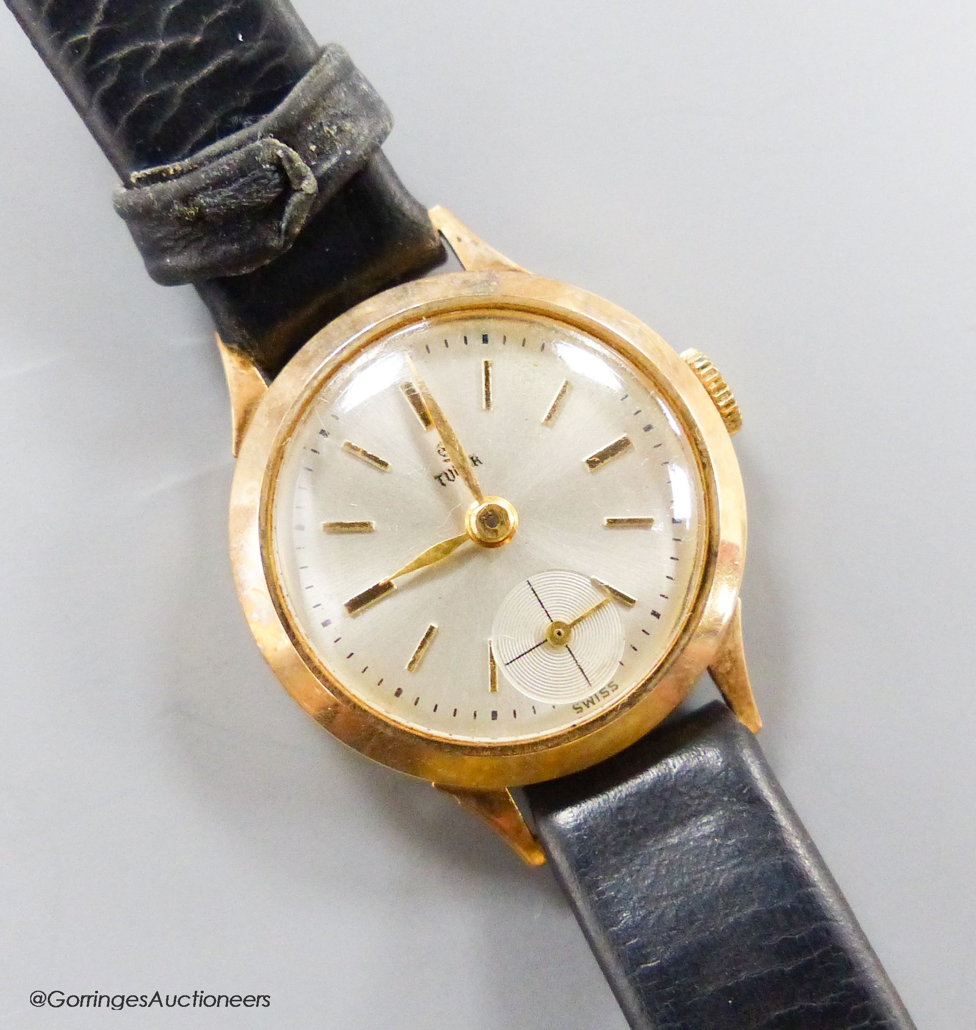 A lady's 9ct gold Tudor manual wind wrist watch, with subsidiary seconds, on a leather strap, with gold plated Rolex buckle, with Tudor box.